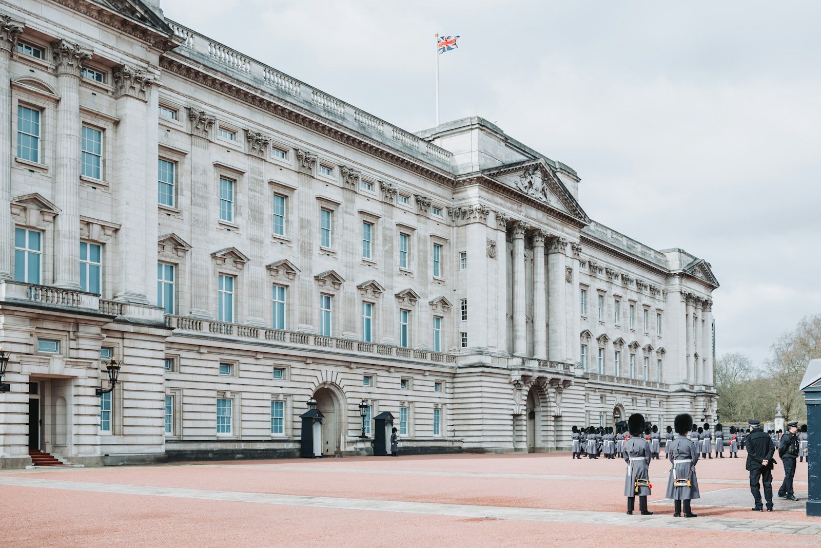 Buckingham Palace with some soldiers in the foreground.