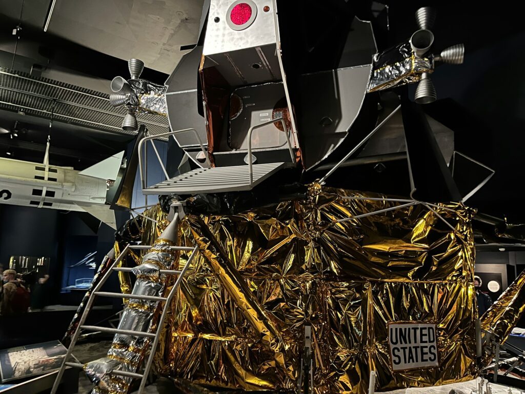 A space station with gold foil covering it at the Science Museum