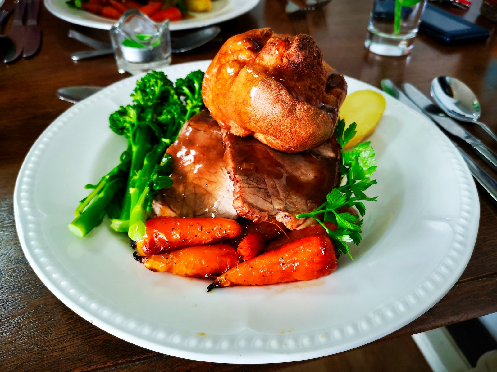 A roast dinner with beef and yorkshire pudding.