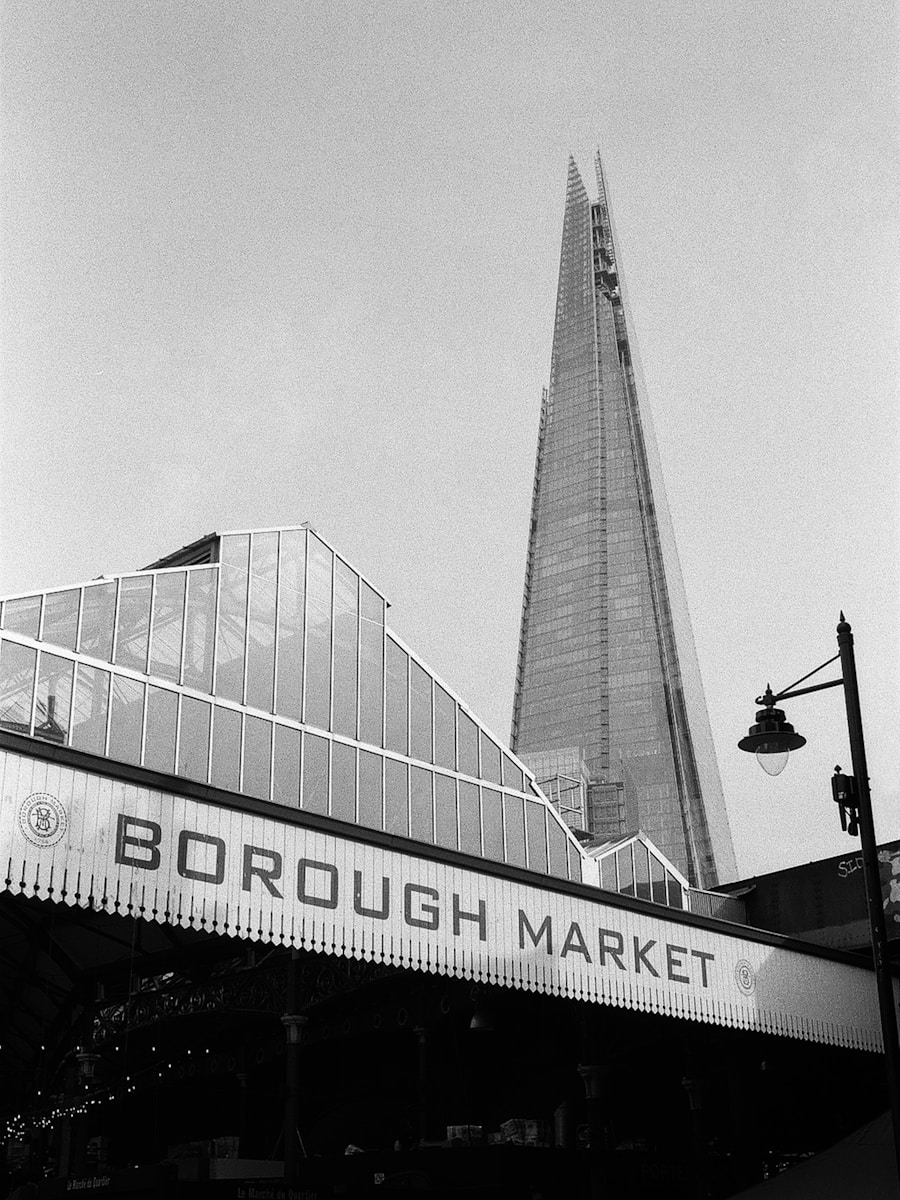 a black and white photo of Borough Market with the Shard in the background.