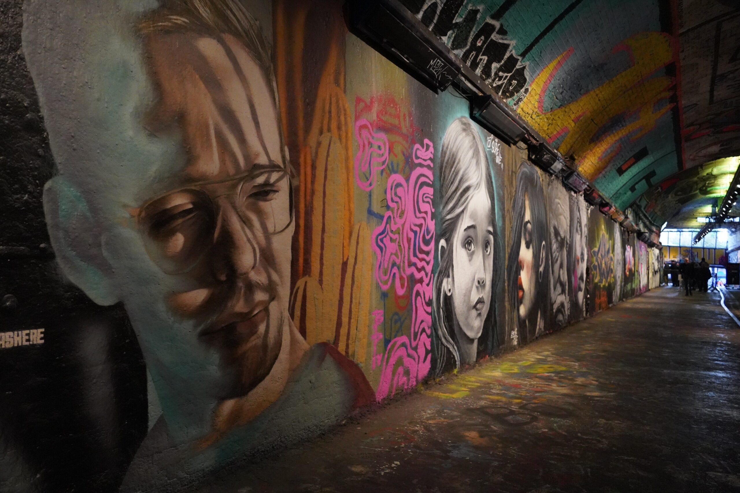 Leake Street art murals painted on the wall of a tunnel