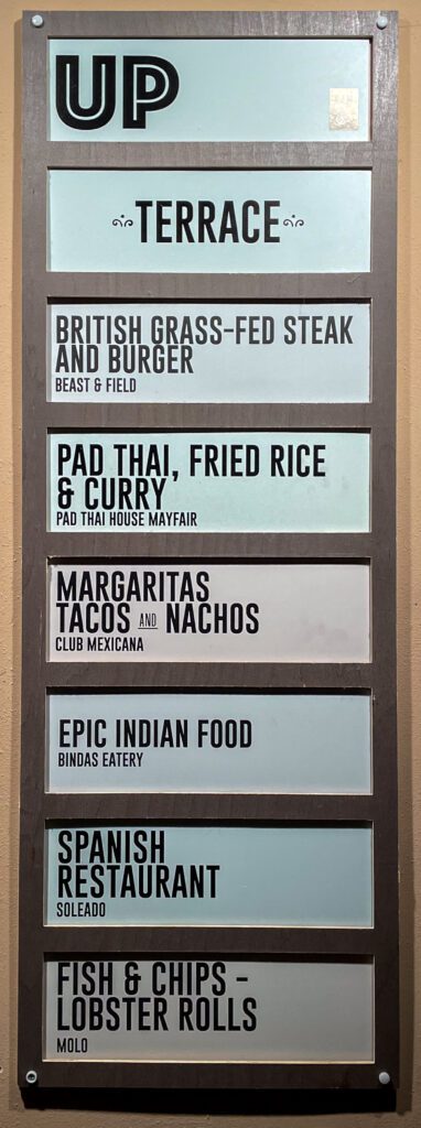 A sign for the food options upstairs at Mercato Mayfair