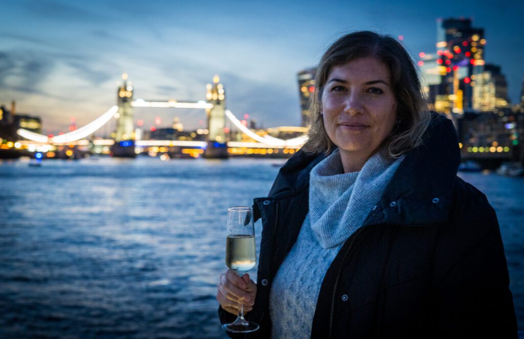 Drinking champagne in front of Tower Bridge while on the Afternoon Tea cruise