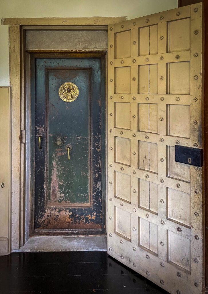 A large metal door leading to a cool box in the kitchen