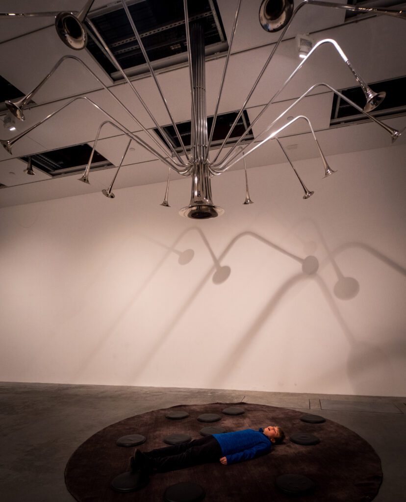 Lying down under an art music installation