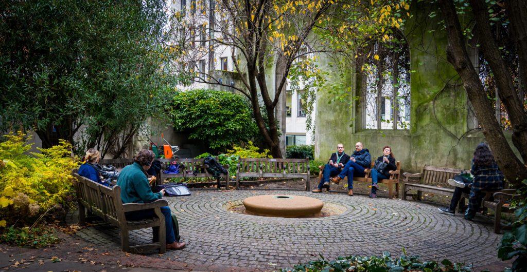 Benches placed in a circle around within church ruins