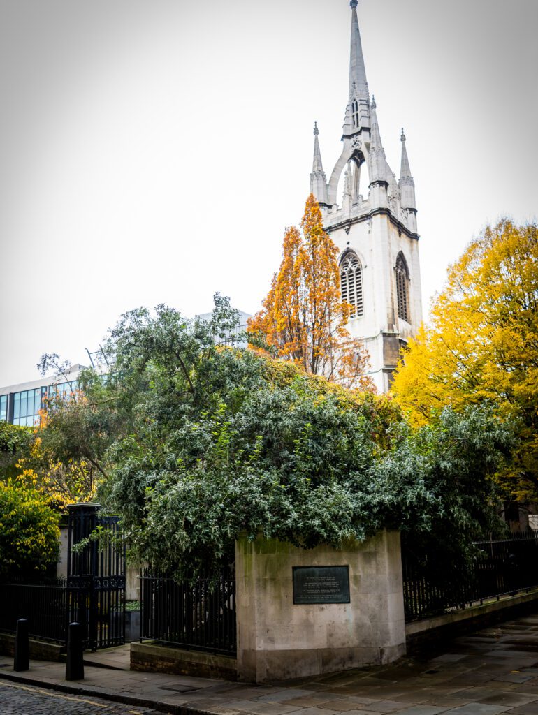Church tower with the entrance to St. Dunstan gardens in the foreground