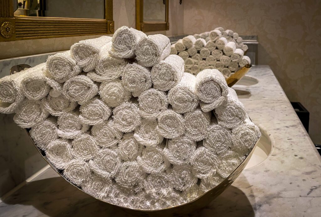 A neat pile of folded hand towels in the toilets