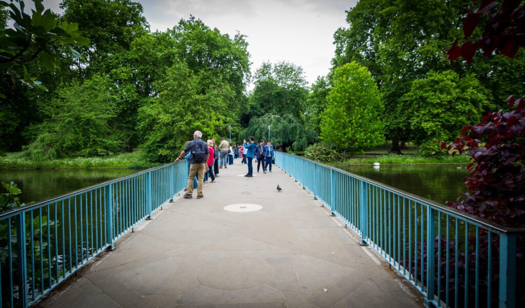 Bridge over a lake with people taking photographs in the middle