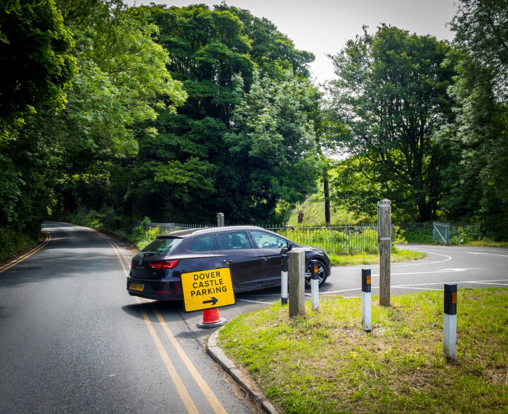 Car driving into the a road towards parking.