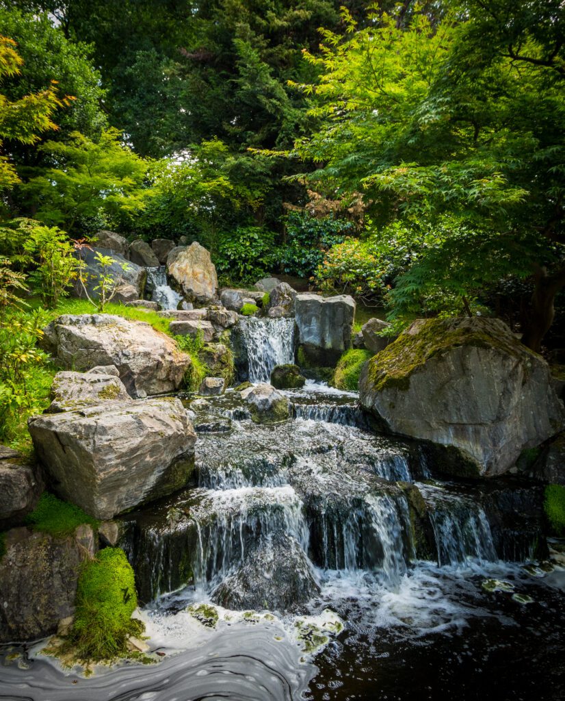 A waterfall with stone boulders