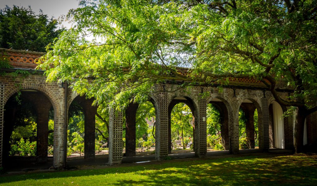 Archways in a stone wall within a park