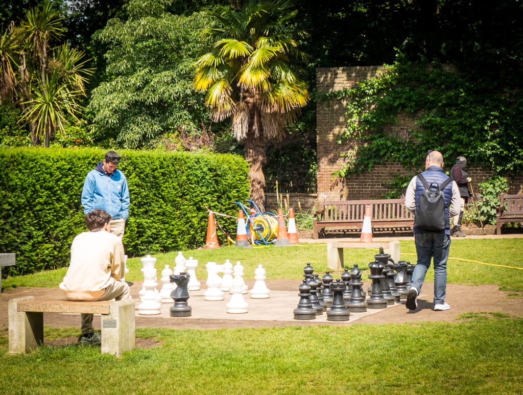 Huge chess set in Holland Park with people playing a game