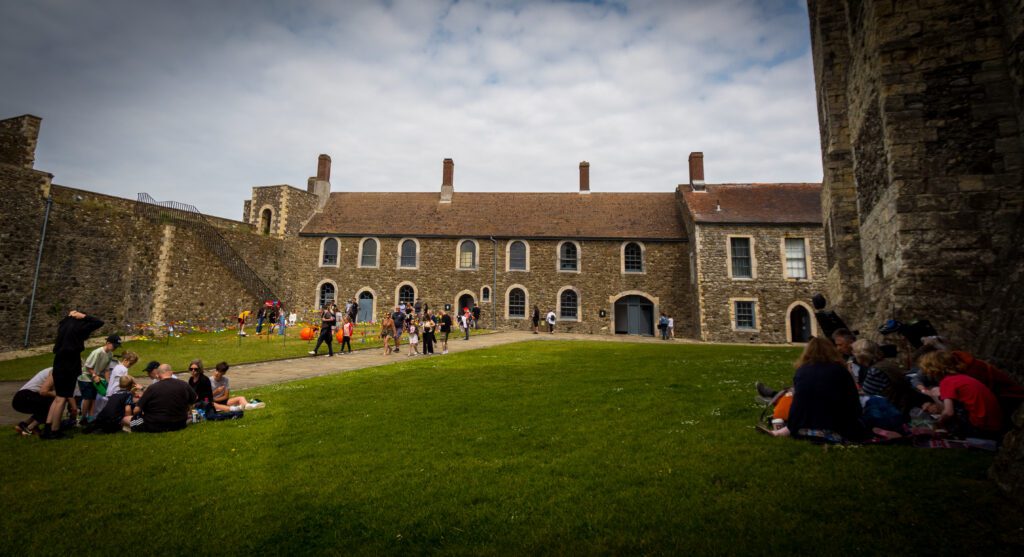 People having a picnic on grass next to the Keep at Dover Castle
