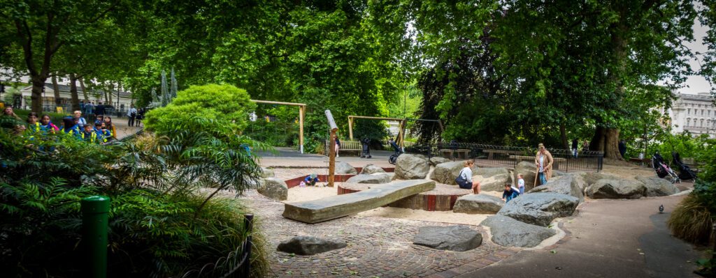 A play area with swings and a sand pit