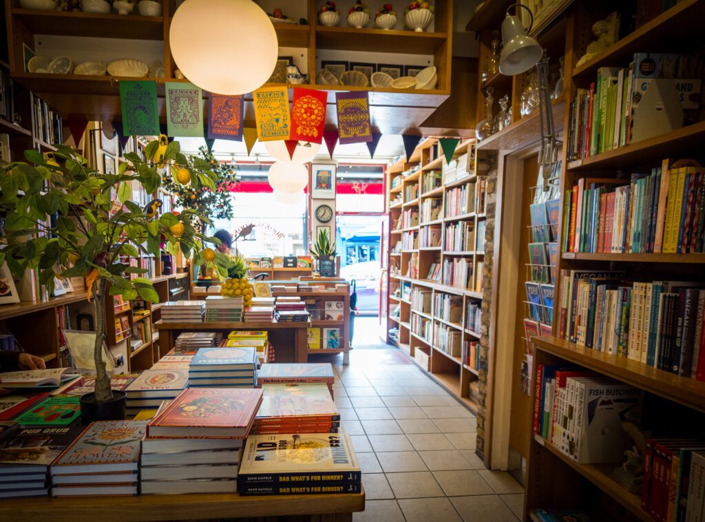 Shelves of cook books for sale inside a shop