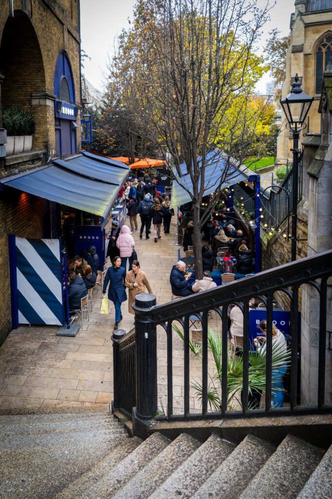 Steps down to some food stalls with seating