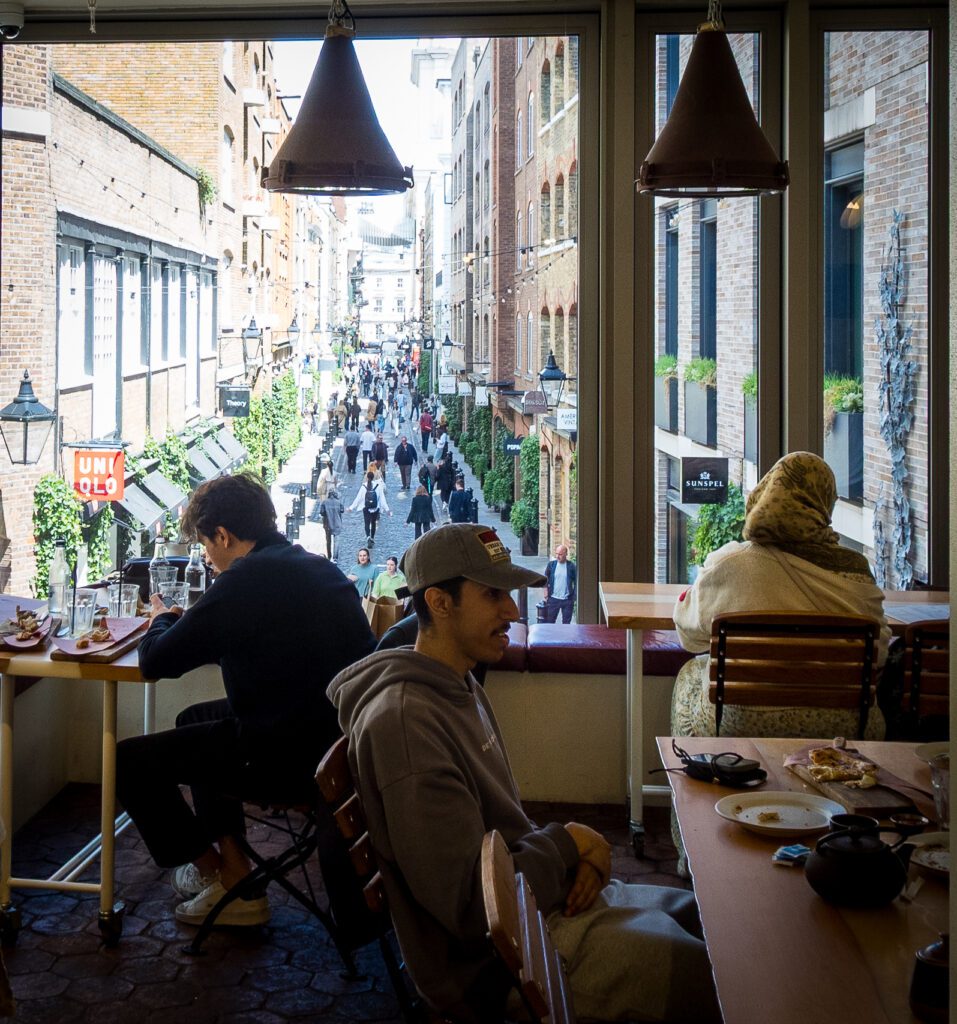 Benches and tables overlooking a busy street