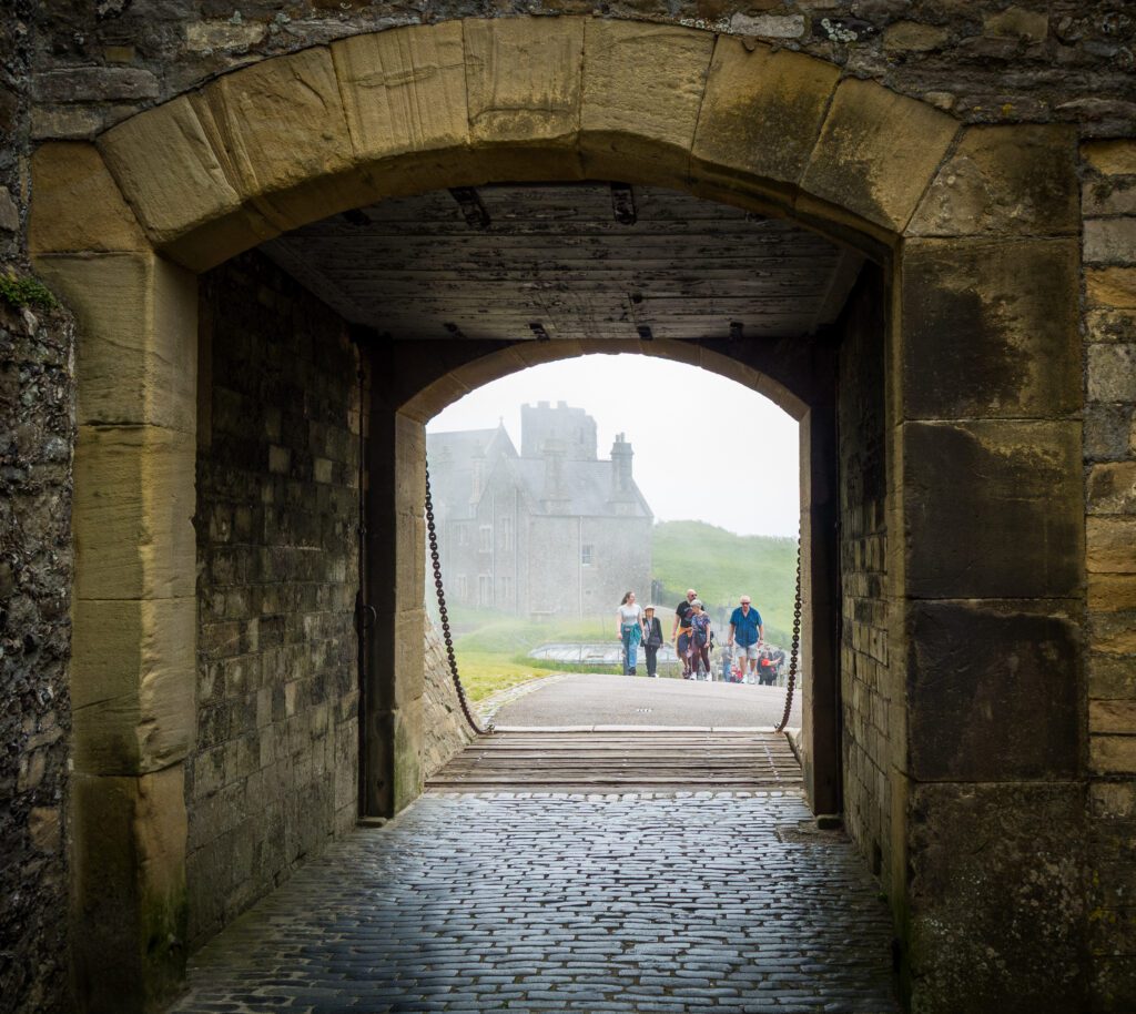 Archway and Portcullis leading towards buildings outside of the castle walls