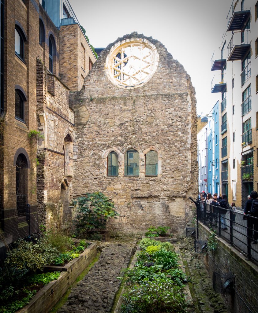 The ruins of Winchester Palace incorporated into a modern building with planting inside troughs.