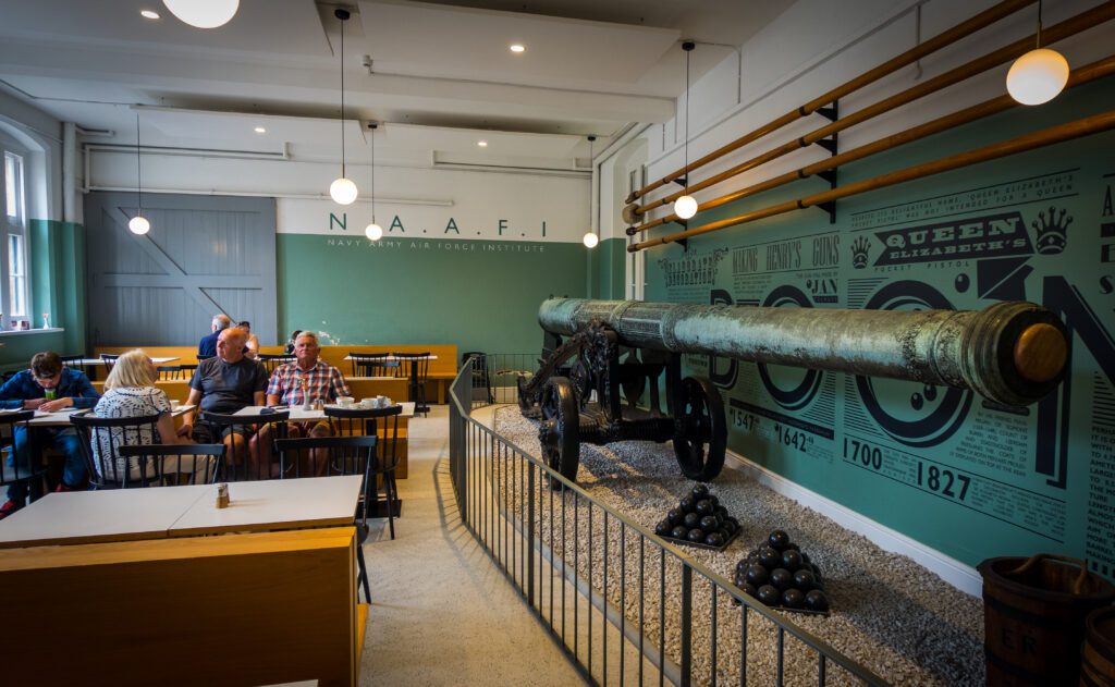 Large Canon Gun next to the seating area in a cafe