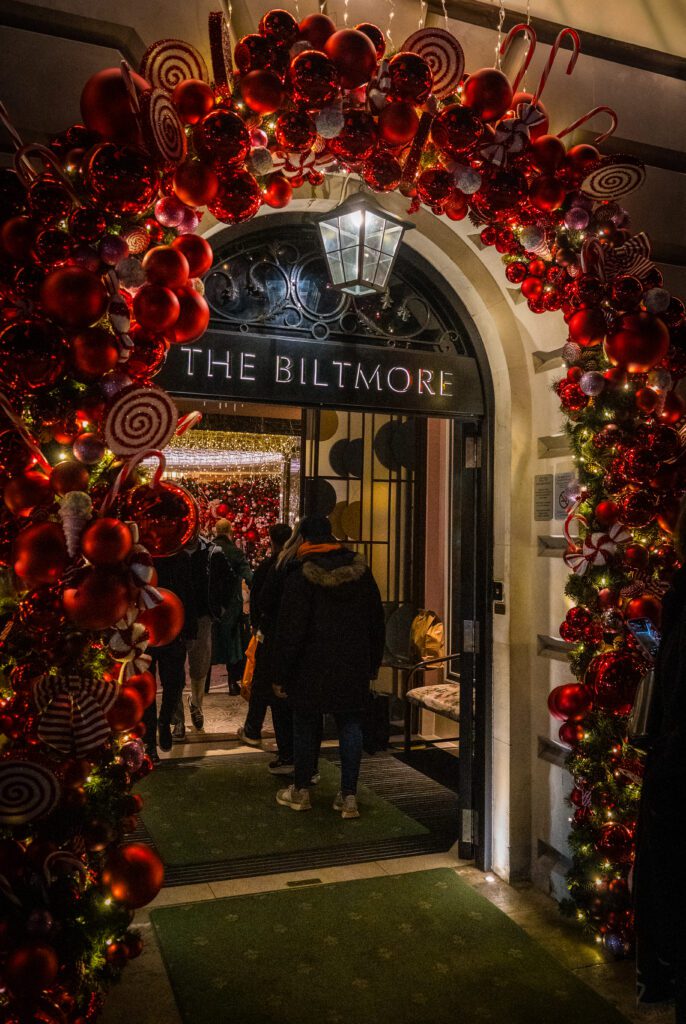 An arch of Christmas decorations surrounding the entrance to The Biltmore Hotel