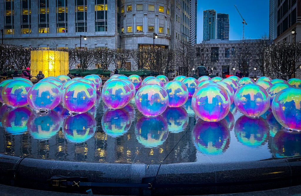 Floating light orbs in water at Canary Wharf