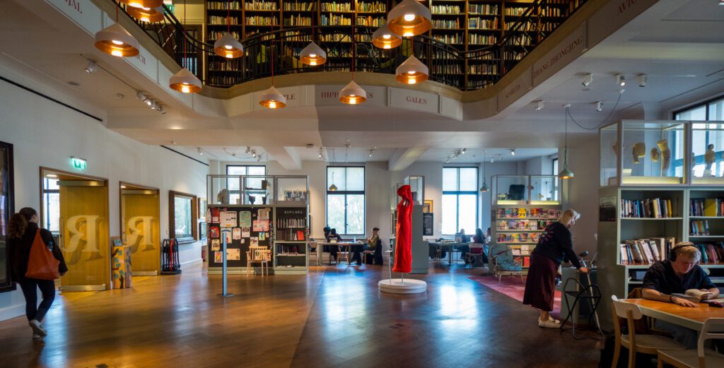 Books to borrow in bookshelves and tables to work or study at in The Reading Room